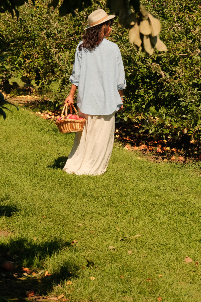 Woman standing in apple orchard during candid lifestyle photography in Ottawa, Ontario